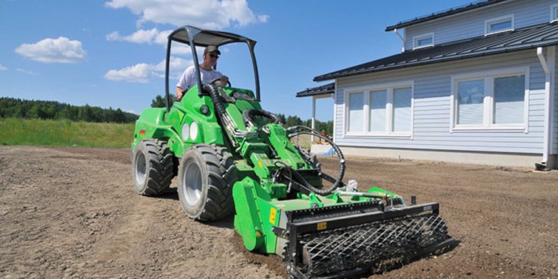 Man driving AVANT 700 Series loader for landscaping business Would something like this be ok? An Avant 700 Series loader operating a stone burier attachement for a landscaping business.